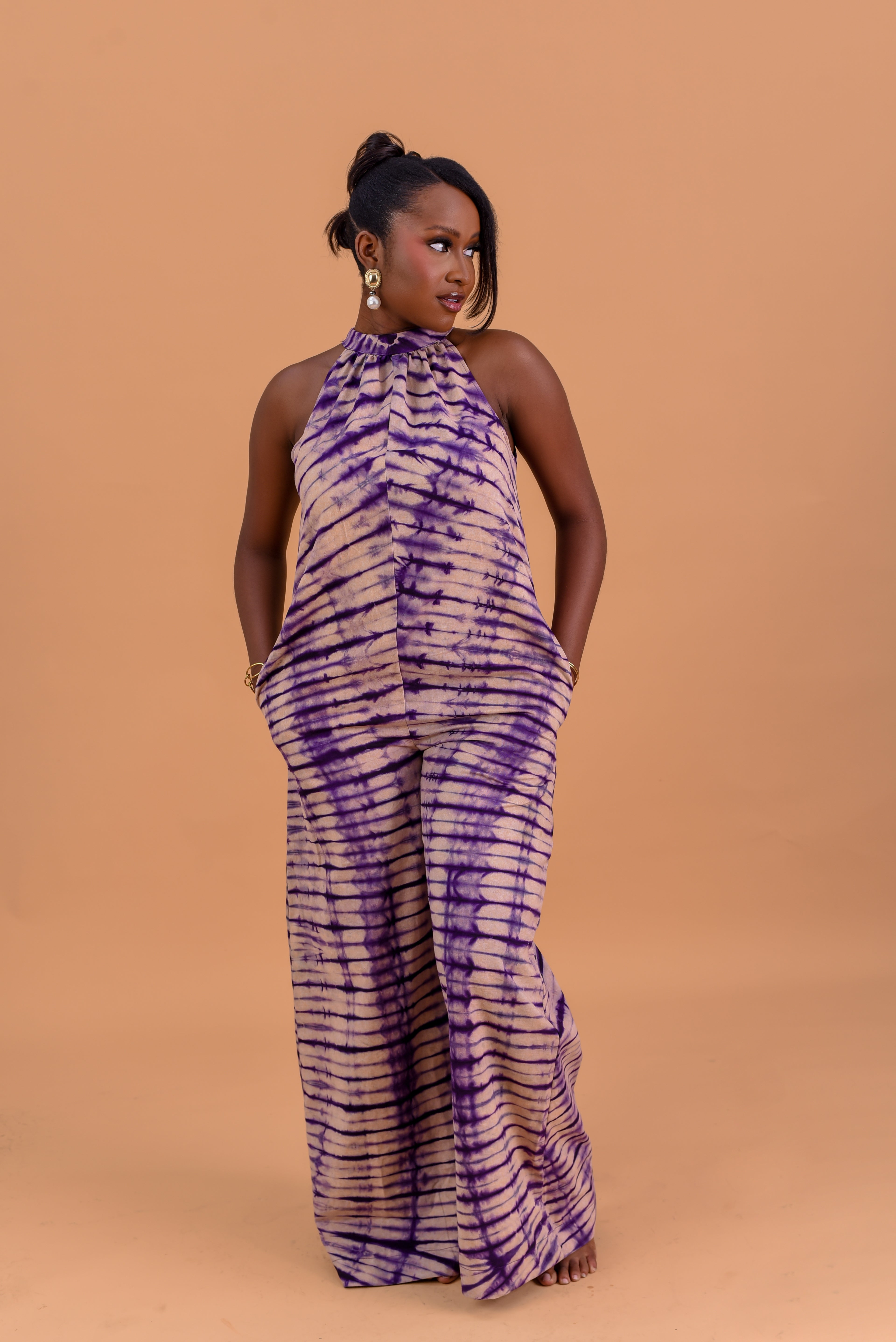 Adire halter neck wide leg jumpsuit in purple and nude tie-dye cotton by Roseline's Closet
Women's African print halter jumpsuit with wide palazzo legs — purple Adire cotton