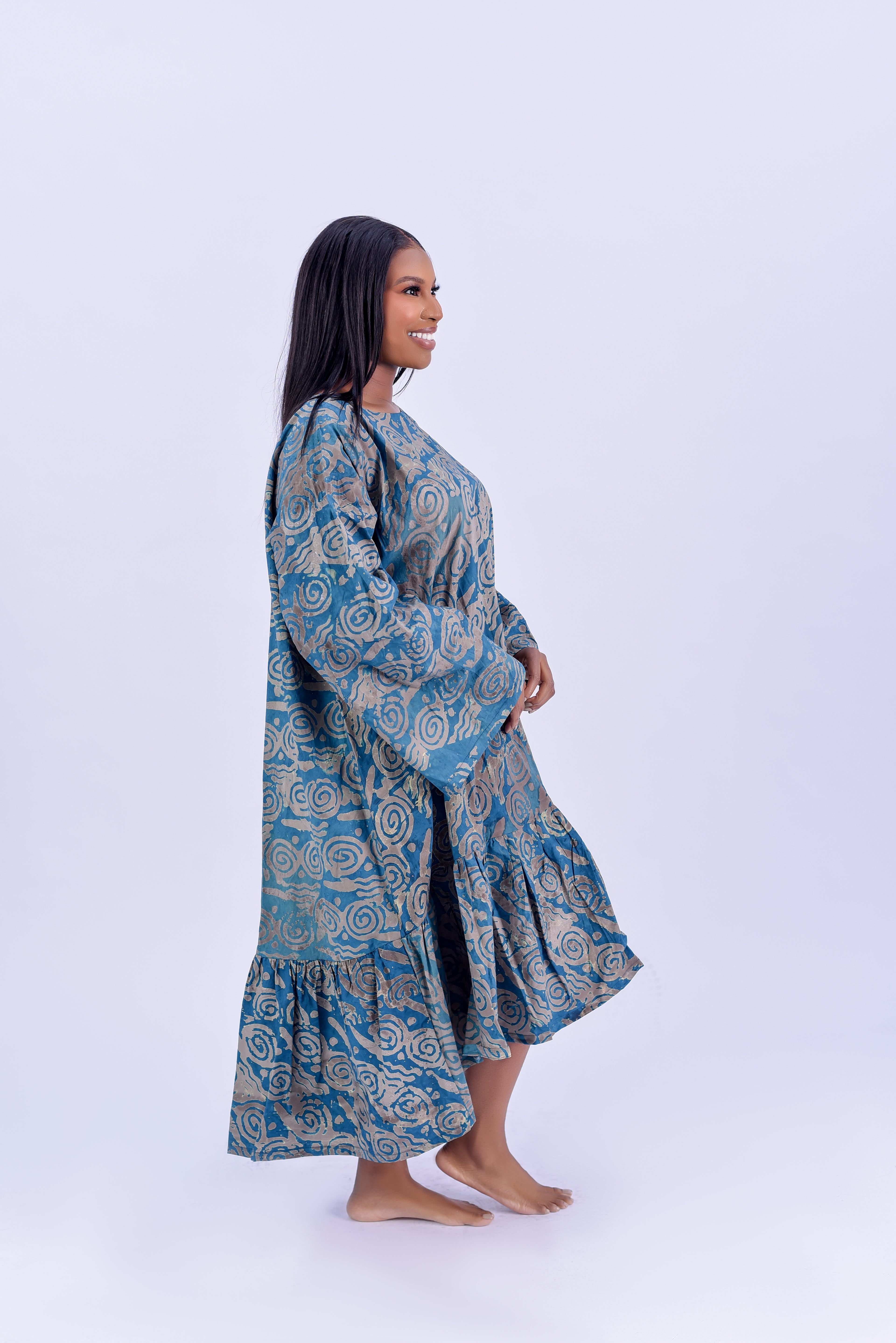 Adire balloon sleeve tiered maxi dress in teal and gold spiral print cotton by Roseline's Closet
Women's African print maxi dress with long balloon sleeves and tiered ruffle hem teal Adire