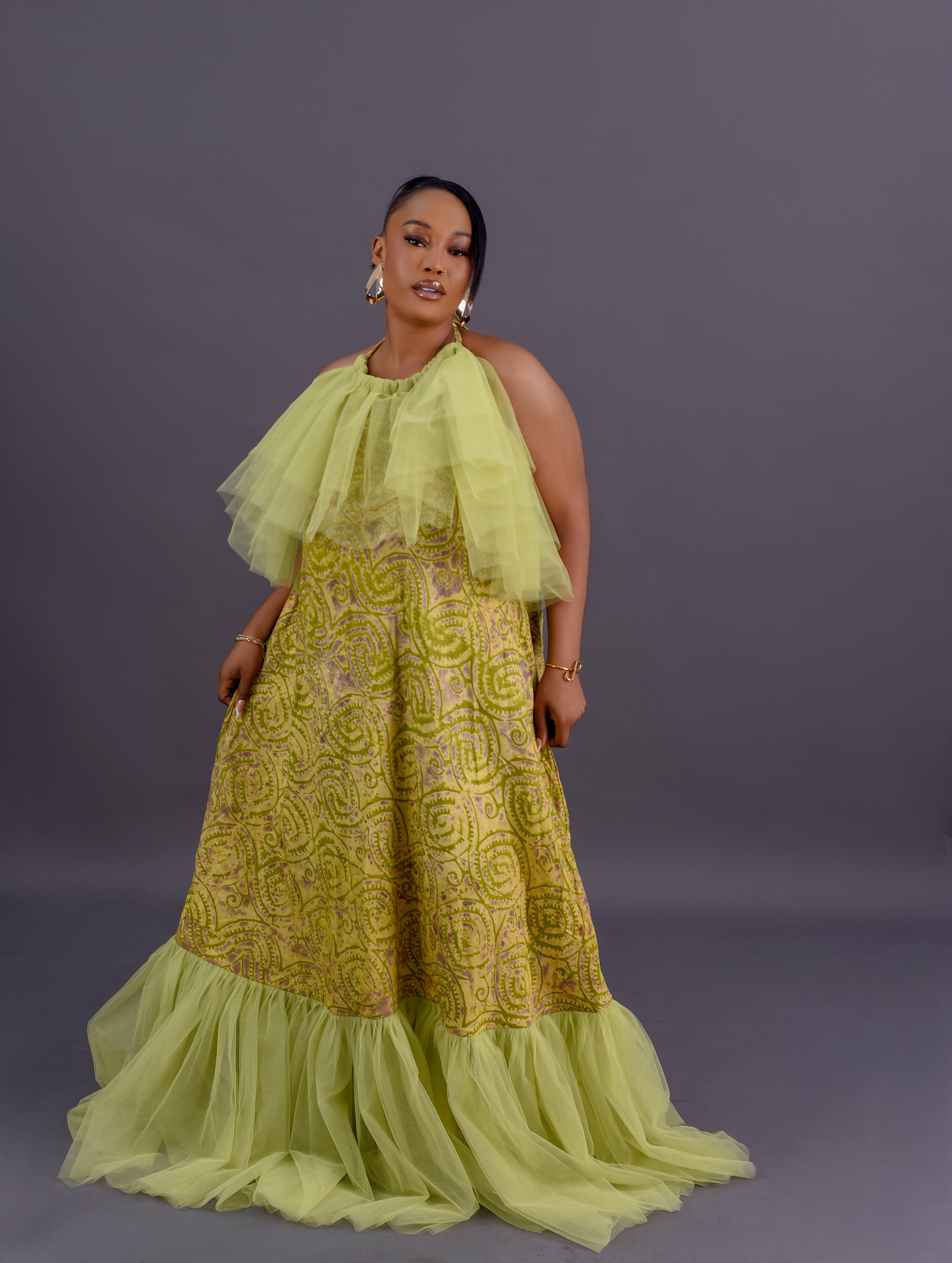 Adire tulle collar halter maxi gown in lime green and gold Adire print with organza ruffle by Roseline's Closet
Women's African print halter maxi gown with dramatic tulle collar and sweeping hem lime green
